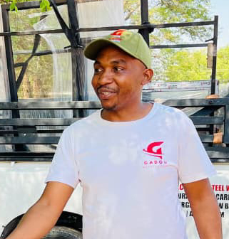 Goodman Madou - Executive Director of Gadou Metal Trading, professional portrait of male executive in industrial setting